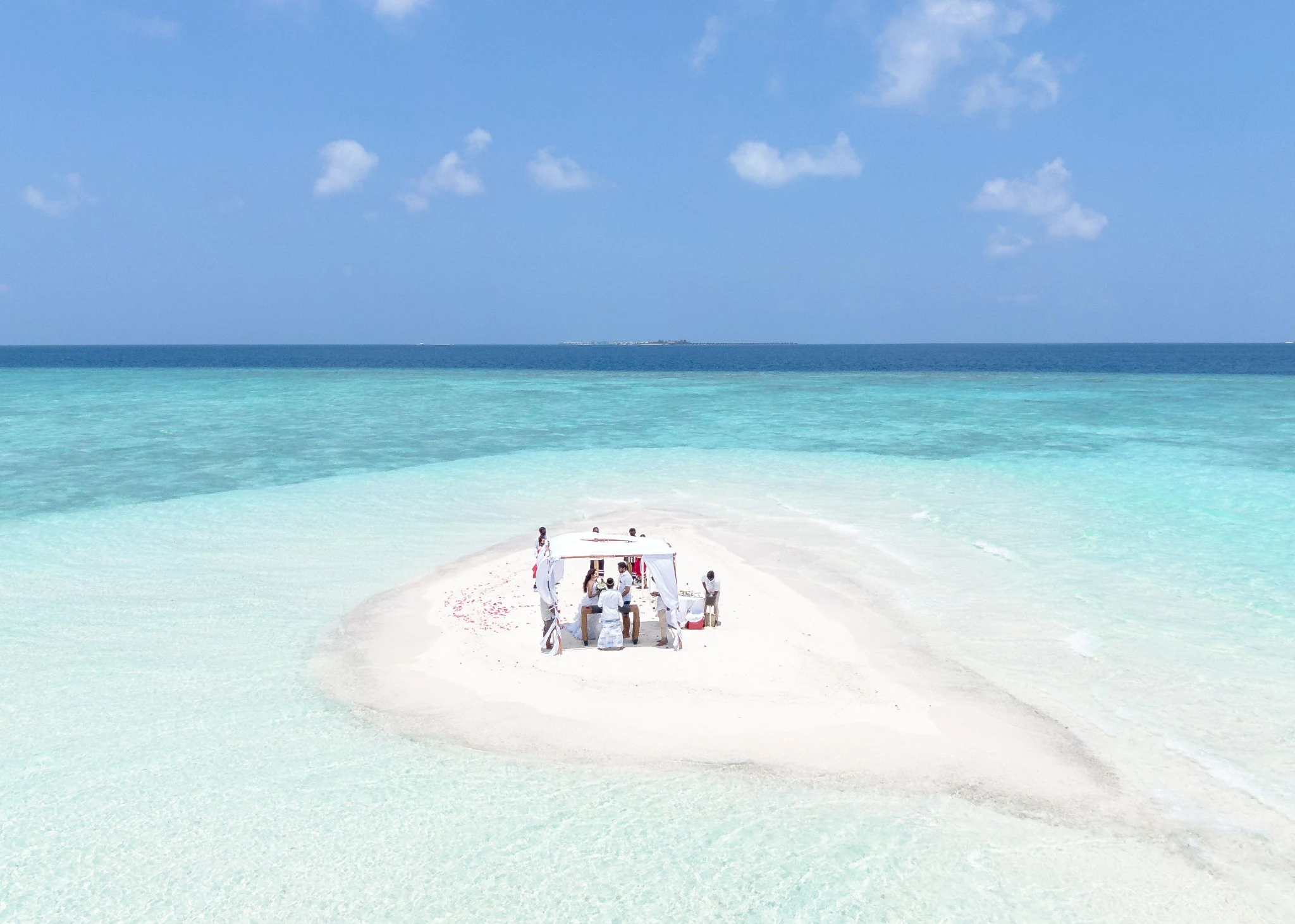 Intimate Maldivian sandbank wedding surrounded by turquoise lagoon