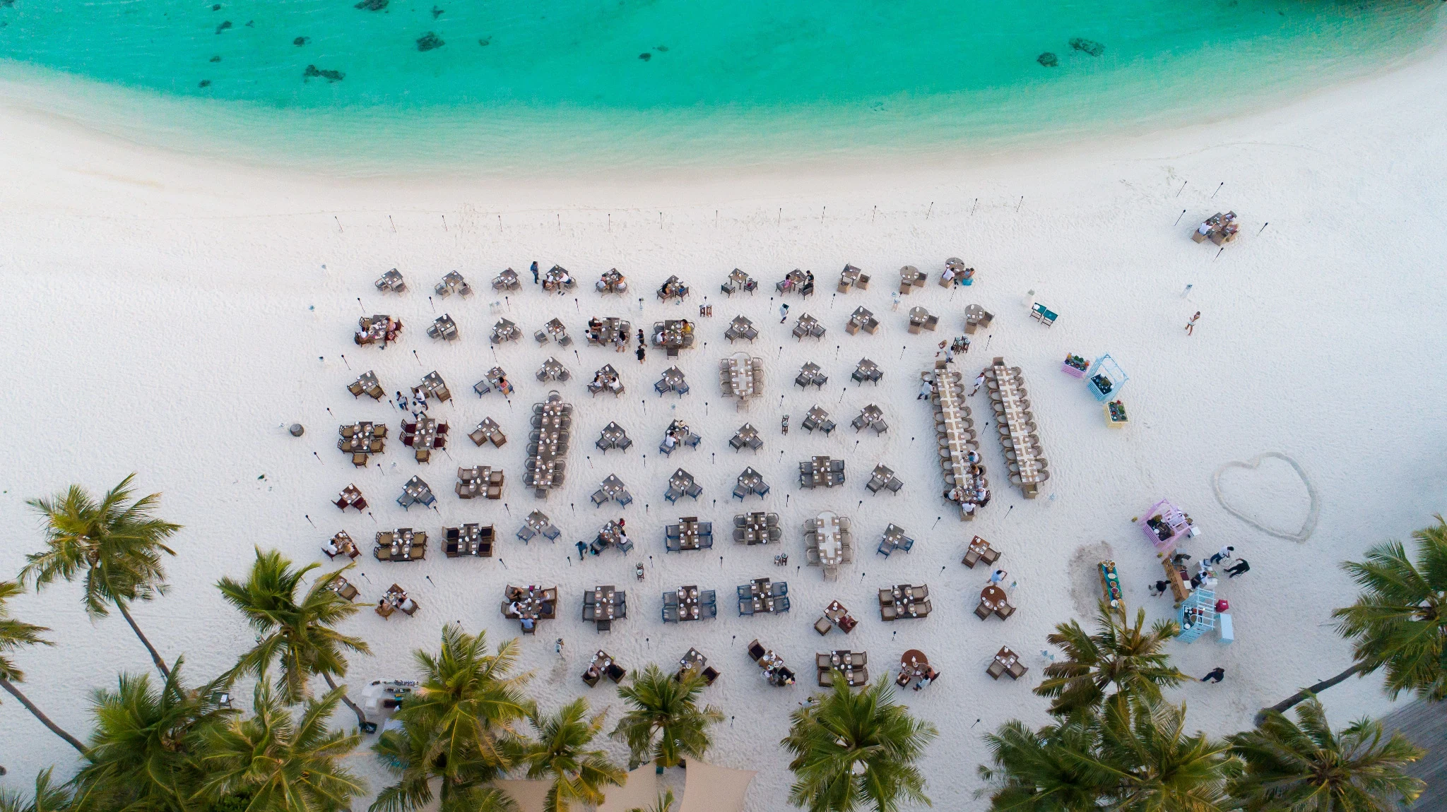 Private-island celebration setup on a Maldivian beach