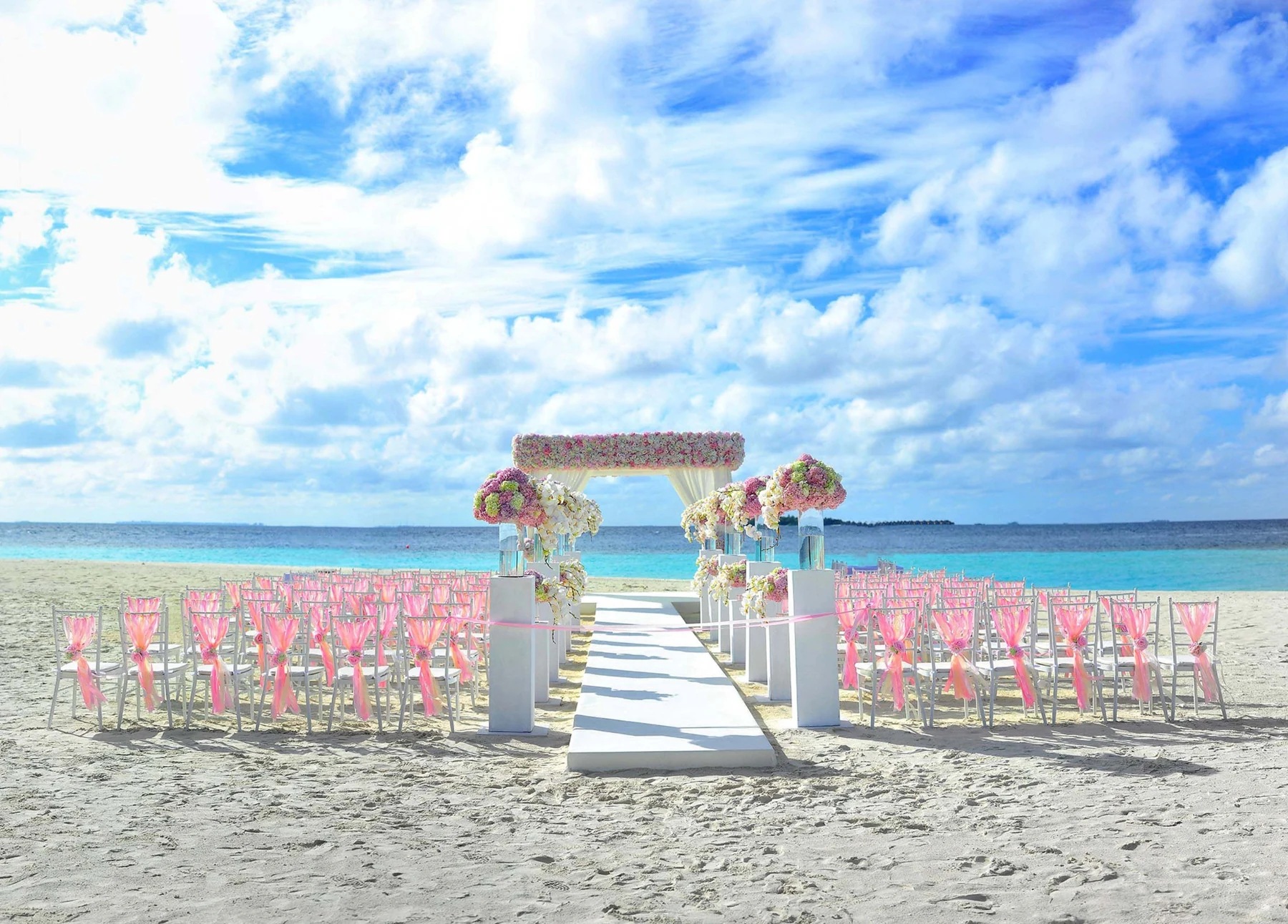 Beach wedding ceremony prepared beside the ocean