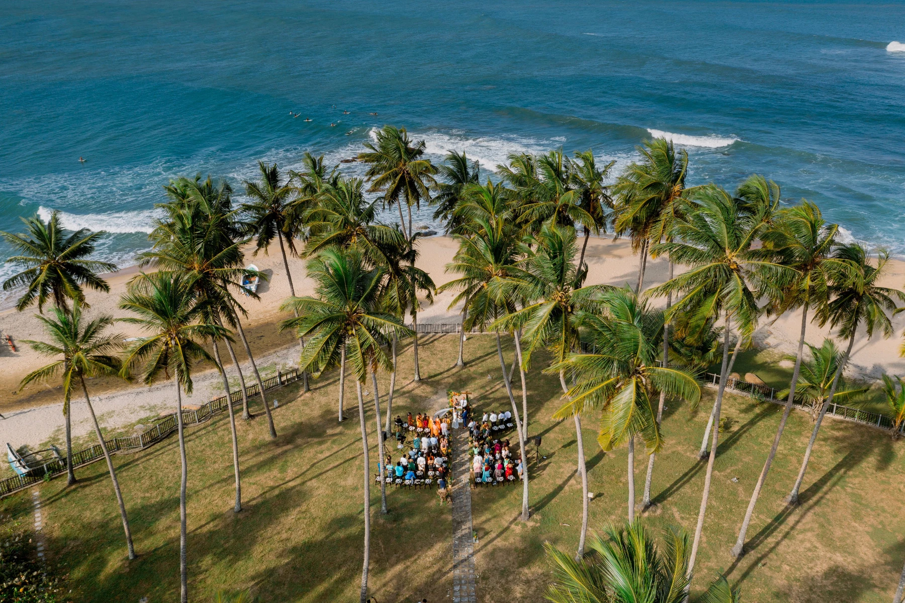 Aerial view of a tropical beachfront wedding celebration